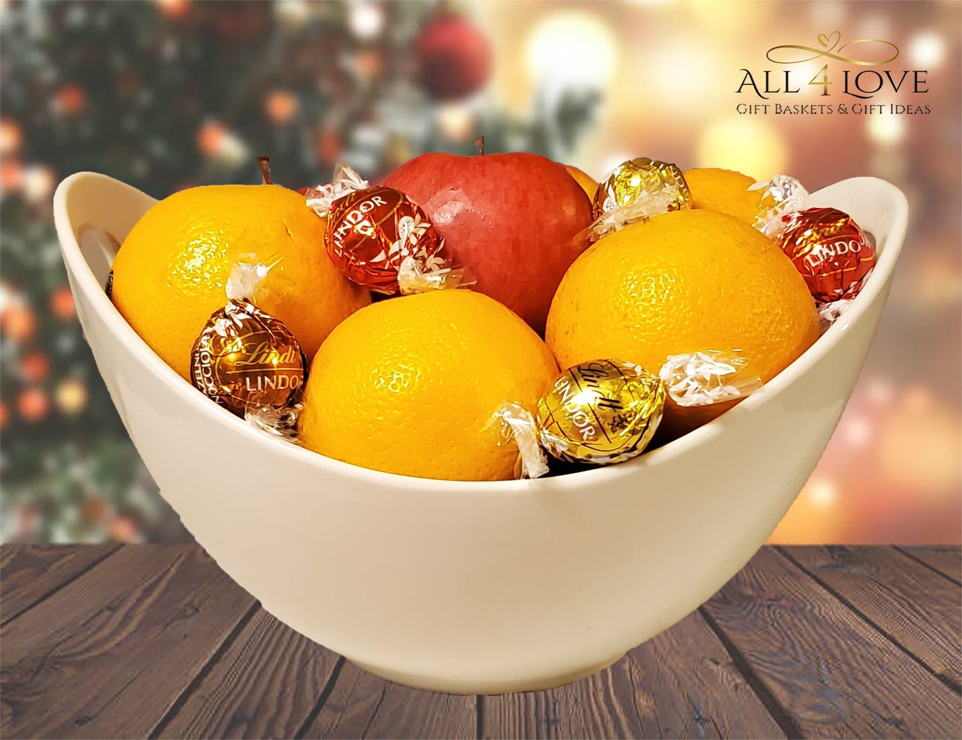 Apples and oranges in ceramic bowl with chocolates