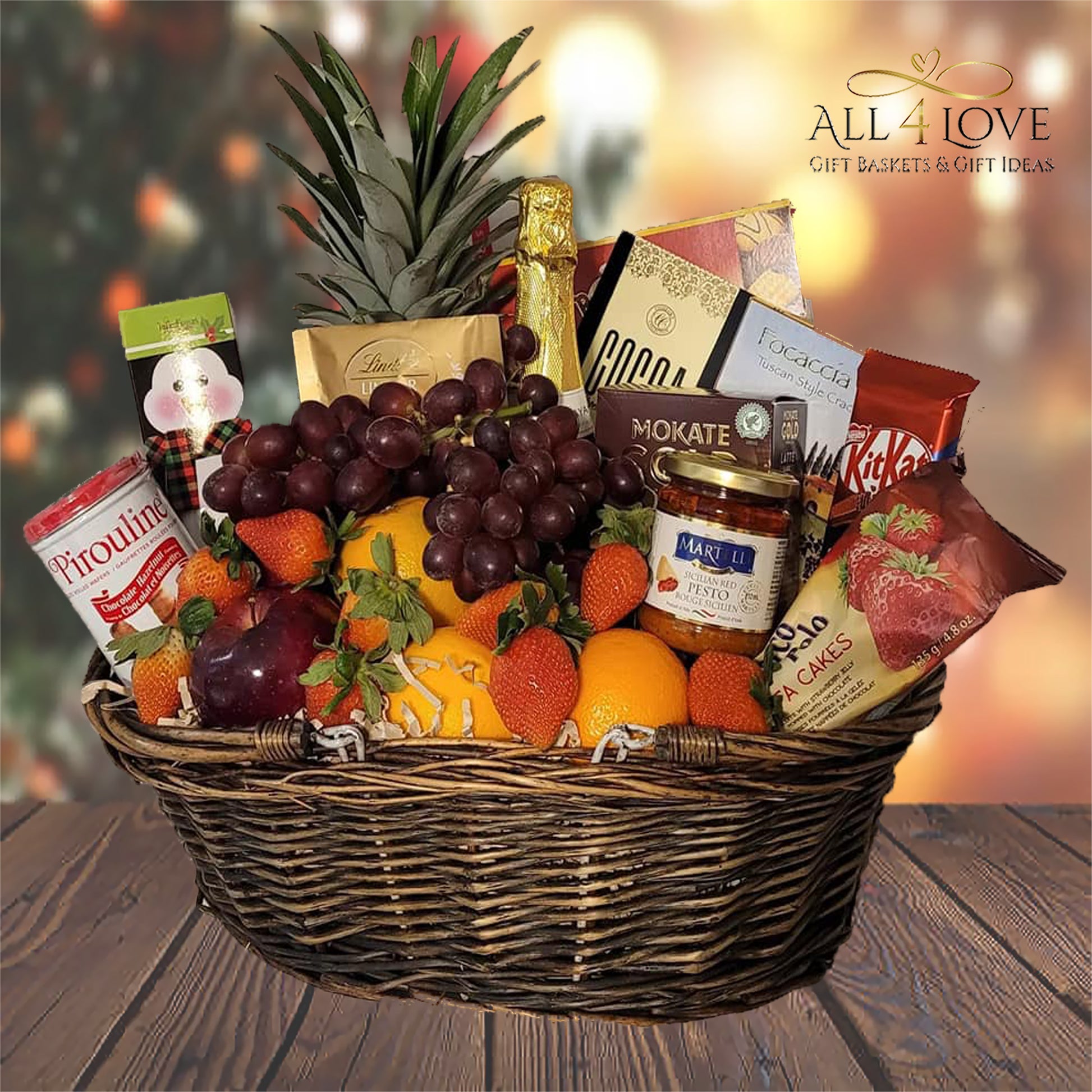 Wicker basket with fruit, sparkling cider and treats